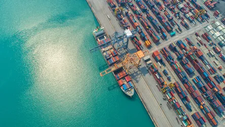 container-ship-in-export-and-import-business-and-logistics-shipping-cargo-to-harbor-by-crane-1086155768