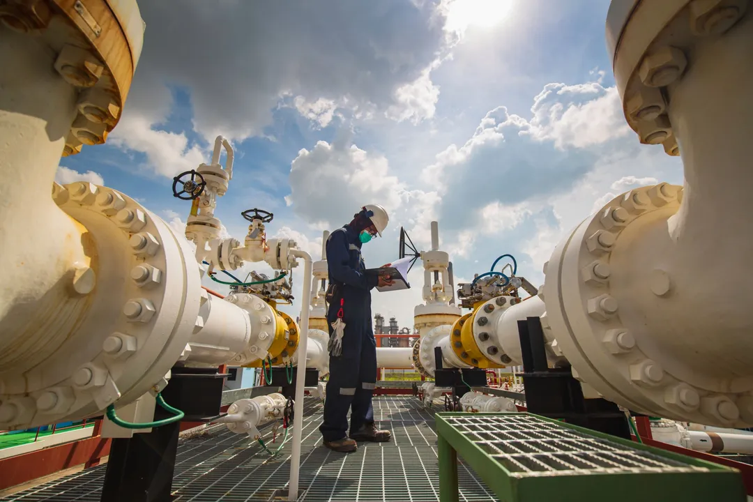 Image showing  male-worker-inspection-at-steel-long-pipes-and-pipe-elbow-in-station-oil-factory-during-refinery-2068701212